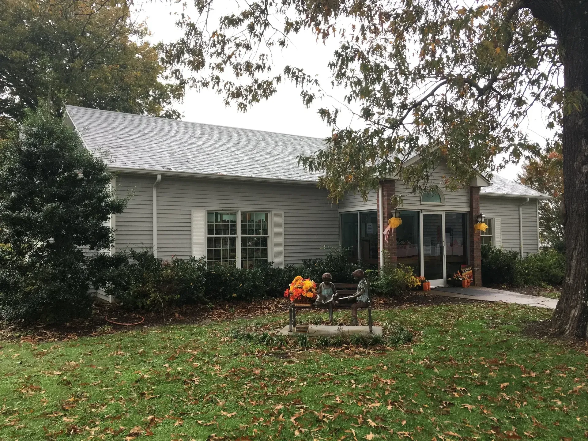 The Loretto Branch Library building surrounded by trees and autumn decorations